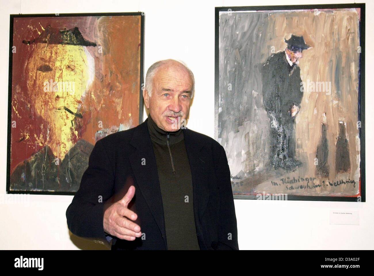 (dpa) - German actor Armin Mueller-Stahl is standing between his paintings 'The Last Good Time II' (L) and 'Schwejk in World War II' in the film museum in Postsdam, 30 January 2001. Mueller-Stahl became internationally famous in Hollywood movies like 'Music Box', 'Shine', 'Night on Earth', and 'Miss Stock Photo