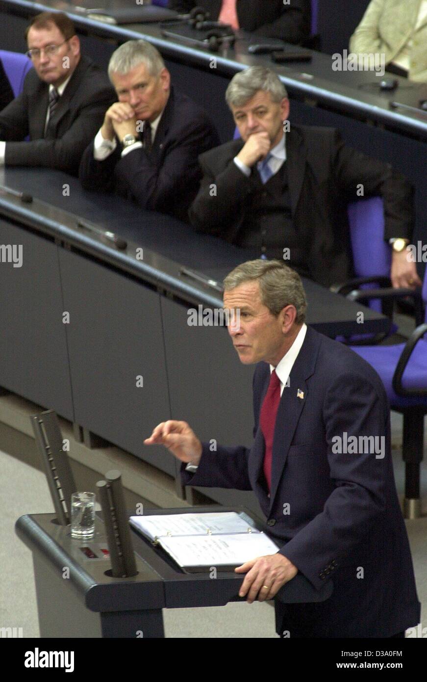 (dpa) - US President George W. Bush delivers his speech in German parliament, the Bundestag in Berlin, while Foreign Minister Joschka Fischer (2nd from R) and Interior Minister Otto Schily (3rd from R) are listening, 23 May 2002. He called for a joint European appearance against the 'enemies of free Stock Photo