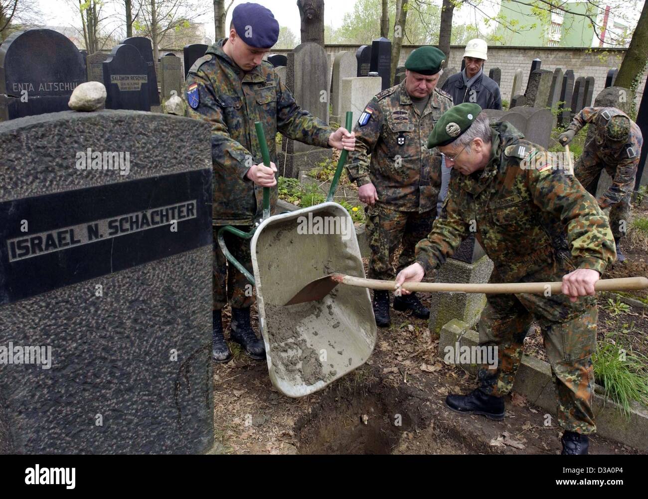 (dpa) - Soldiers of the German Bundeswehr lay the foundations for new tombstones at the cemetery of the Jewish community in Berlin, 18 April 2002. The soldiers set up tombstones for the Jews who were assassinated in the concentration camps of the Nazis during World War II. Stock Photo