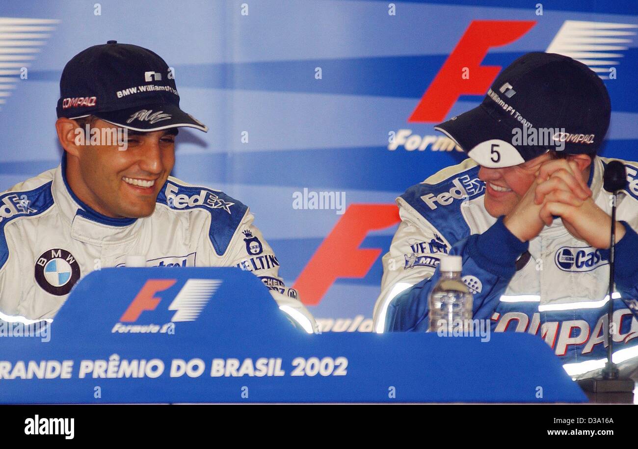 (dpa) - Juan Pablo Montoya (L), Colombian formula 1 pilot, and his German team mate Ralf Schumacher rejoicing over their positions they won during the qualifying training in Interlagos near Sao Paulo, 30 March 2002. Stock Photo