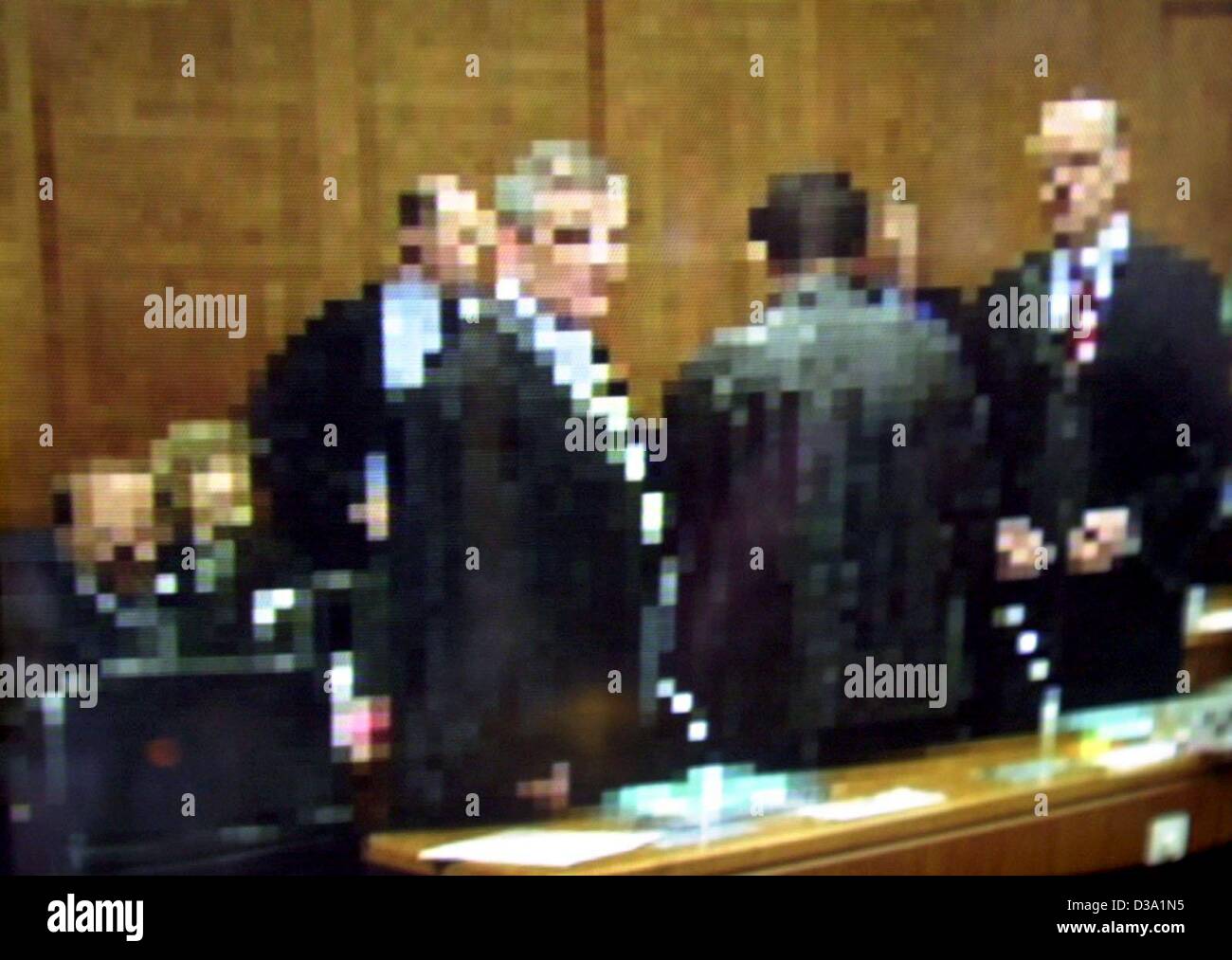 (dpa) - The accused at the socalled Al Qaeda trial stand inside the courtroom of the Higher Regional Court in Frankfurt, 16 April 2002, prior to the opening of the trial. - Notice: This is a video grab from German TV station ZDF especially blurred since the court had ruled that all trial participant Stock Photo