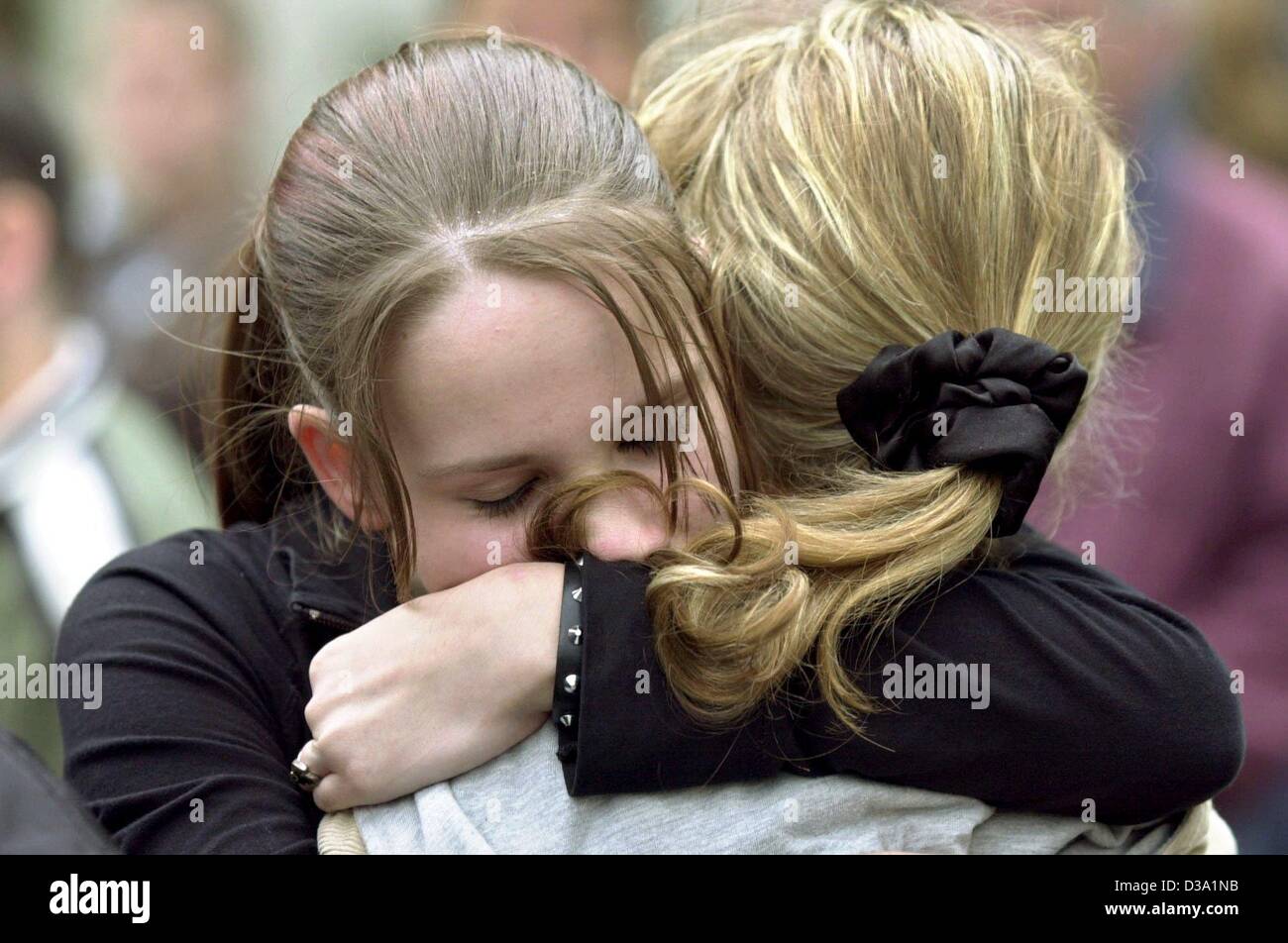 (dpa) - These two girls are safe - they survived the amok tragedy in a school in Erfurt, 26 April 2002. A 19-year-old former pupil of the 'Gutenberg Gymnasium' ran amok and shot himself after having killed 17 others, among them teachers and one policeman. Four people got hurt, but more than a hundre Stock Photo