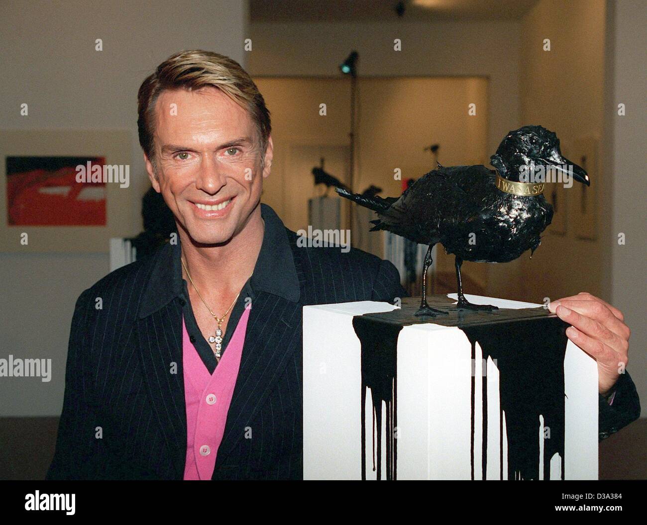 (dpa files) - Wolfgang Joop, German designer and couturier, pictured at the opening of his artwork exhibition 'Belle Ile - Is black beautiful?' in Berlin, 3 March 2000. Ecological disasters had inspired Joop to his work: A bird, covered with several layers of varnish-oil paint and a glittering ring  Stock Photo