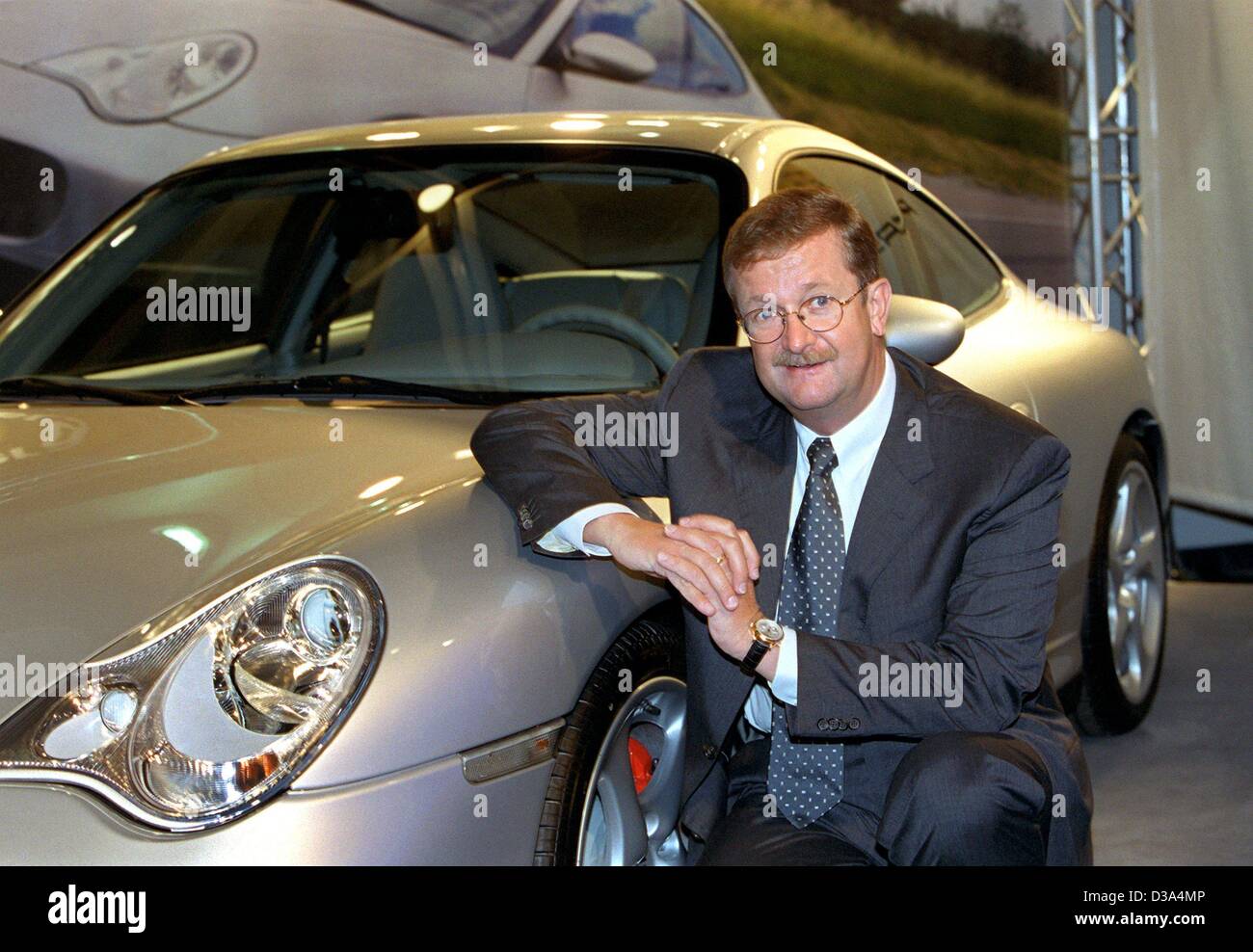 (dpa) - Wendelin Wiedeking, CEO of the German sports car manufacturer Porsche, is posing next to a 911 Carrera 4S at the International Motor Show in Frankfurt, September 2001. The supervisory board recently extended Wiedeking's contract until 2007. Under his management Porsche has become one of the  Stock Photo