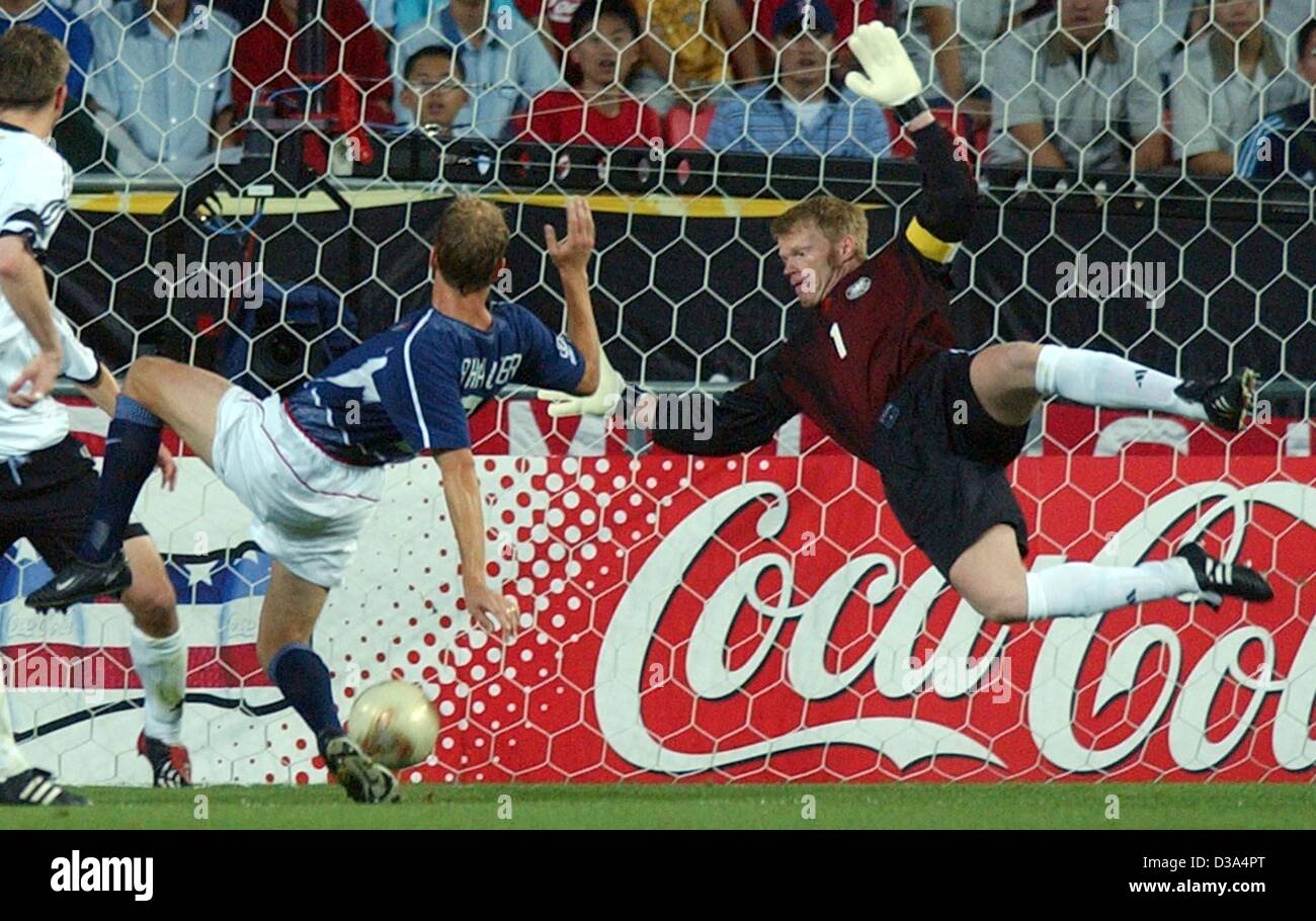 (dpa) - Oliver Kahn (R), goalkeeper and team captain of the German team, makes a spectacular dive to save the ball from the US American Gregg Berhalter during the quarter final match versus the US at the Soccer World Cup in Ulsan, South Korea, 21 June 2002. Germany beat the United States 1:0 and wil Stock Photo