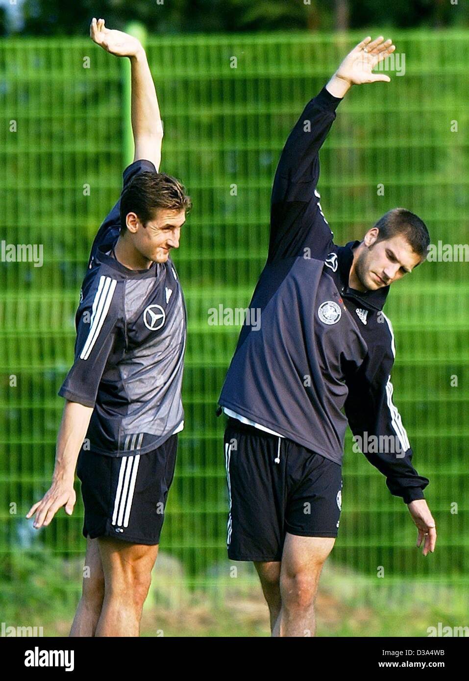 (dpa) - German team players Miroslav Klose (L) and Torsten Frings stretch during a training session for the Soccer World Cup in Seogwipo, South Korea, 18 June 2002. Stock Photo