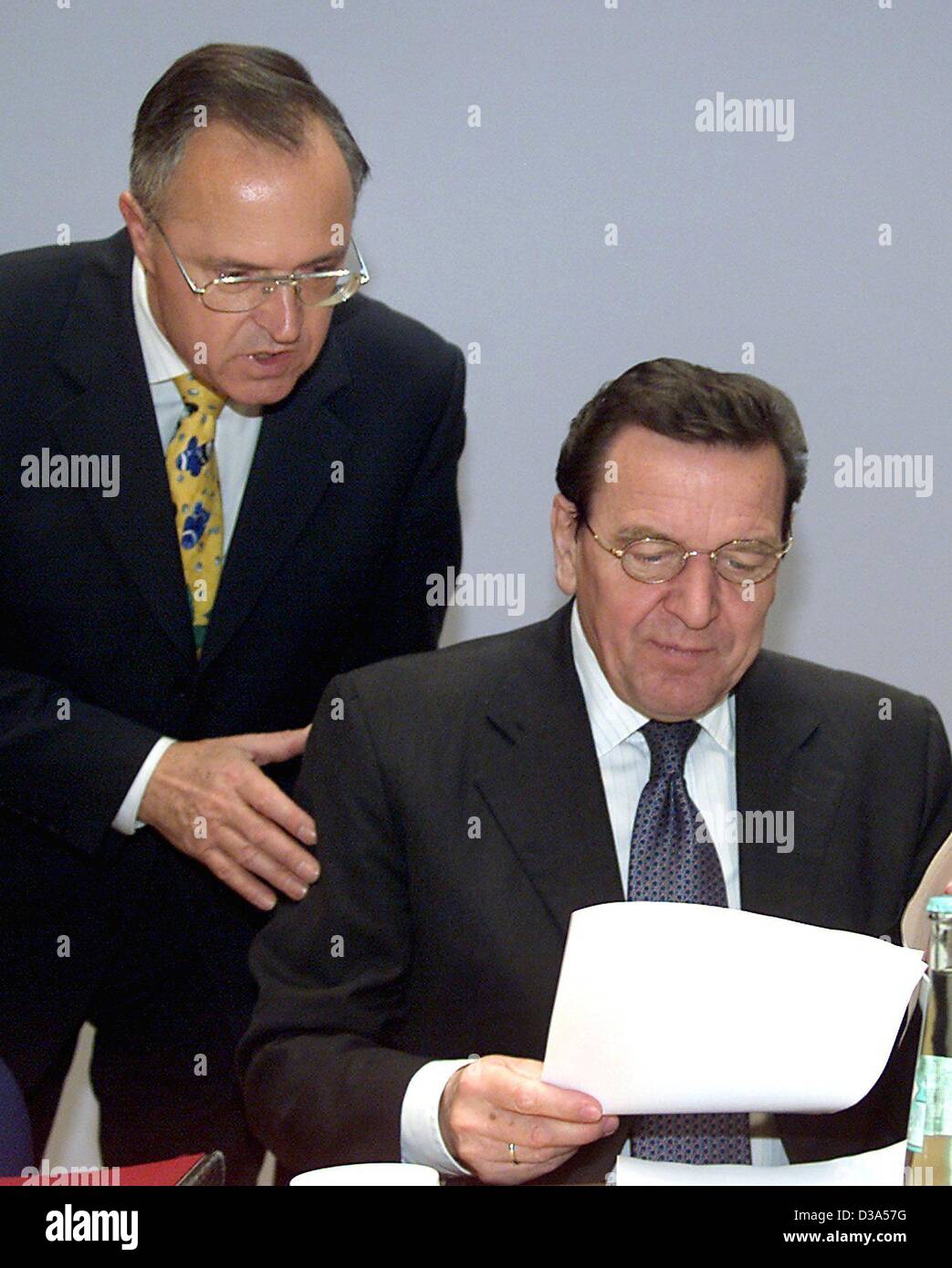 (dpa) - The German Finance Minister Hans Eichel (L) is looking over Chancellor Gerhard Schroeder's shoulder during a conference of the party executive in Berlin, 12 November 2001. Military action in Afghanistan was one of the subjects on the agenda. Stock Photo