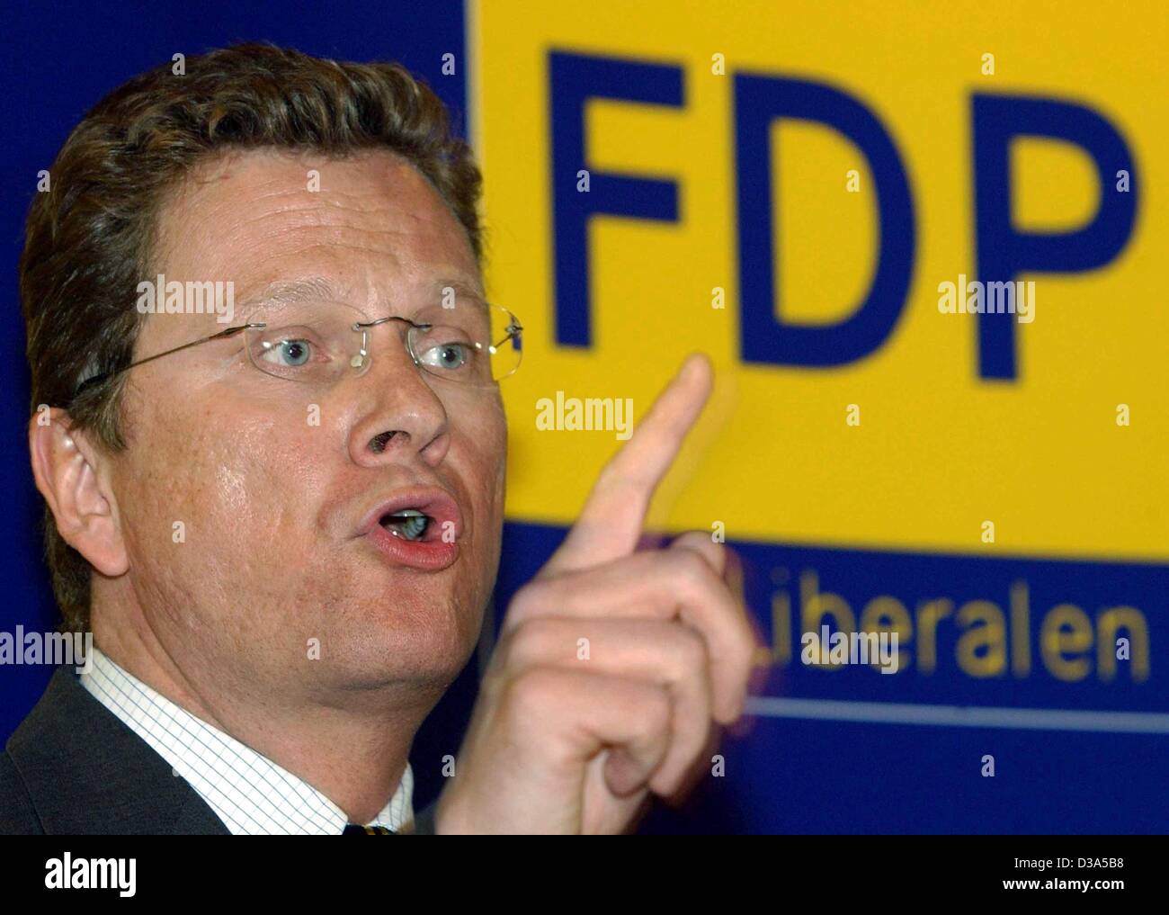 (dpa) - Guido Westerwelle, Chairman of the German liberal party FDP, speaks in front of his party's logo at a party meeting in Passau, Germany, 13 February 2002. In the general elections on 22 September 2002 Westerwelle is running for chancellor, which makes him the first chancellor candidate in the Stock Photo