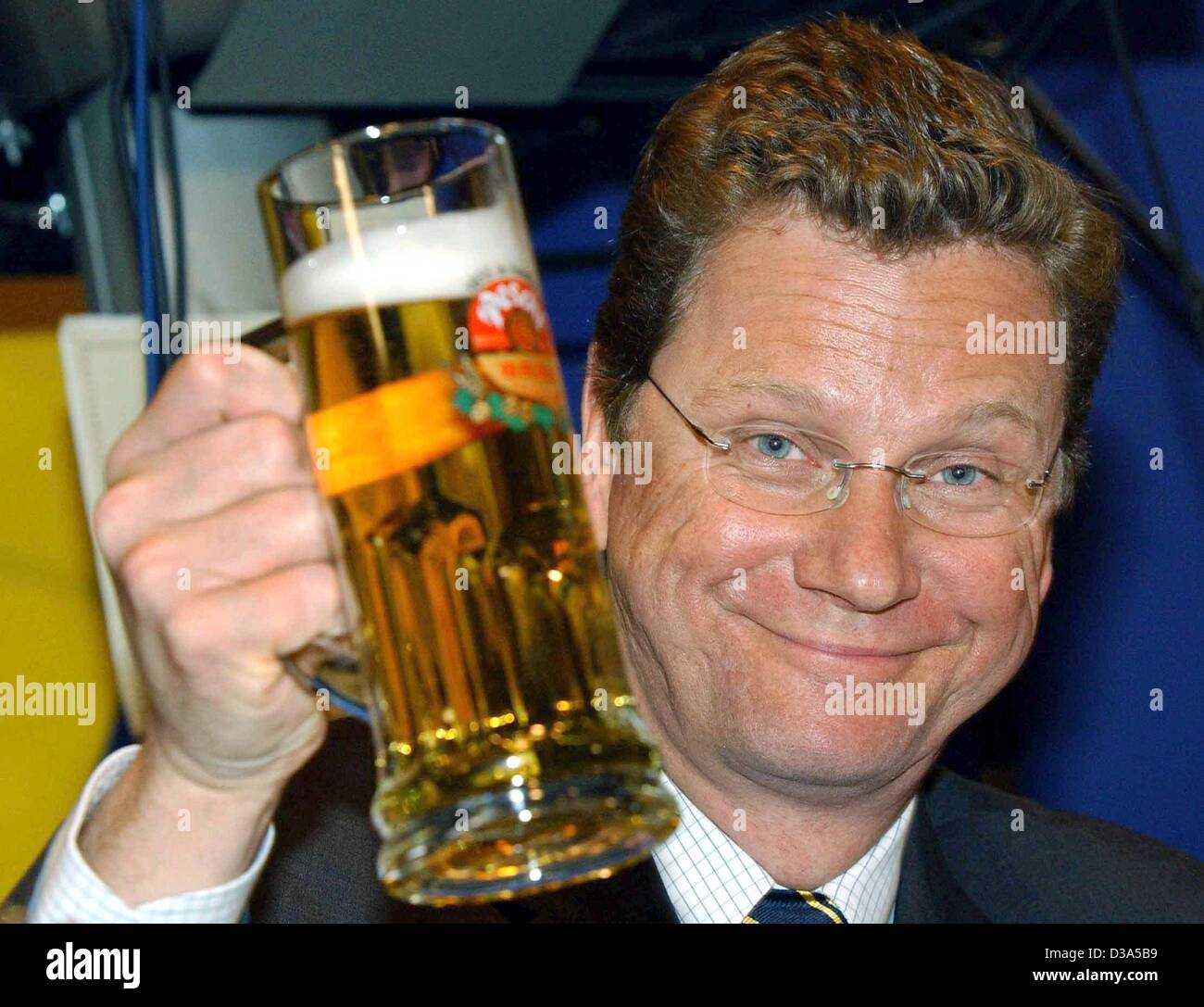 (dpa) - Guido Westerwelle, Chairman of the German liberal party FDP, enjoys a beer after a speech at a party meeting in Passau, Germany, 13 February 2002. Westerwelle has been nominated as the FDP's chancellor candidate in this year's general elections on 22 September, which makes him the first chan Stock Photo