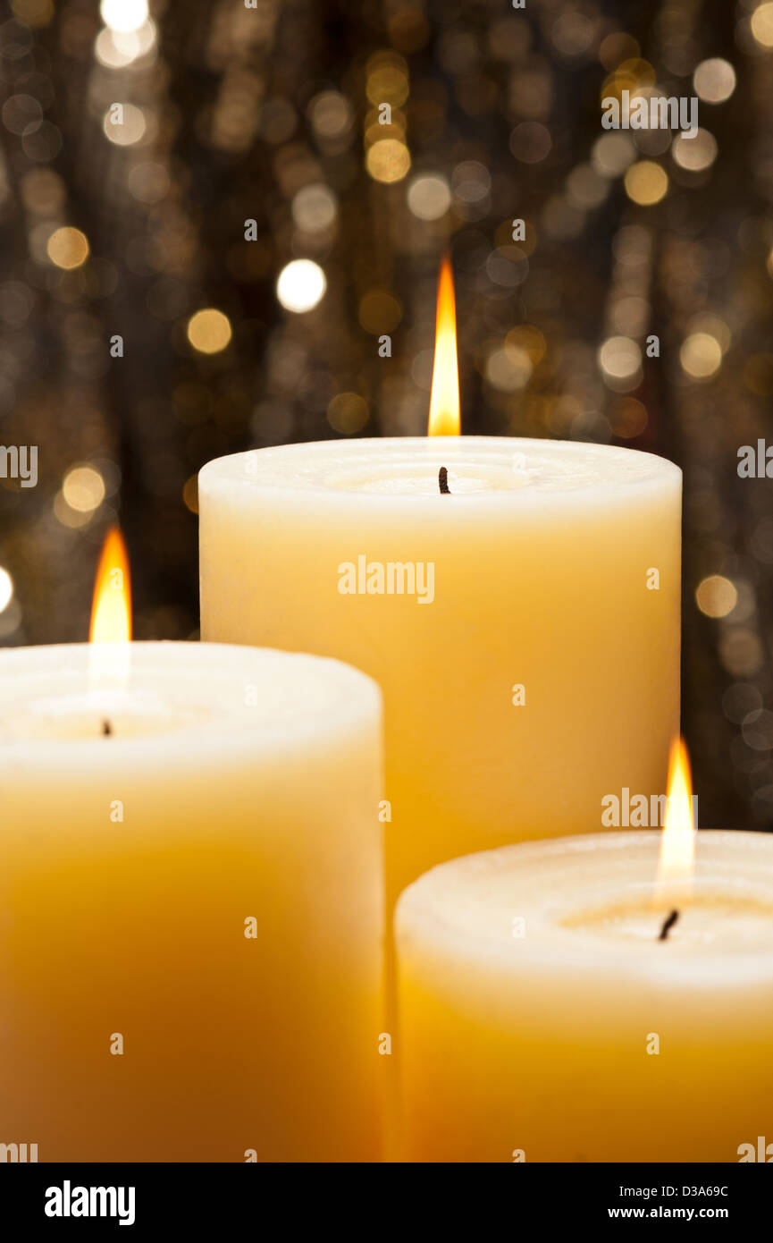 Candles in front of a gold glitter background Stock Photo