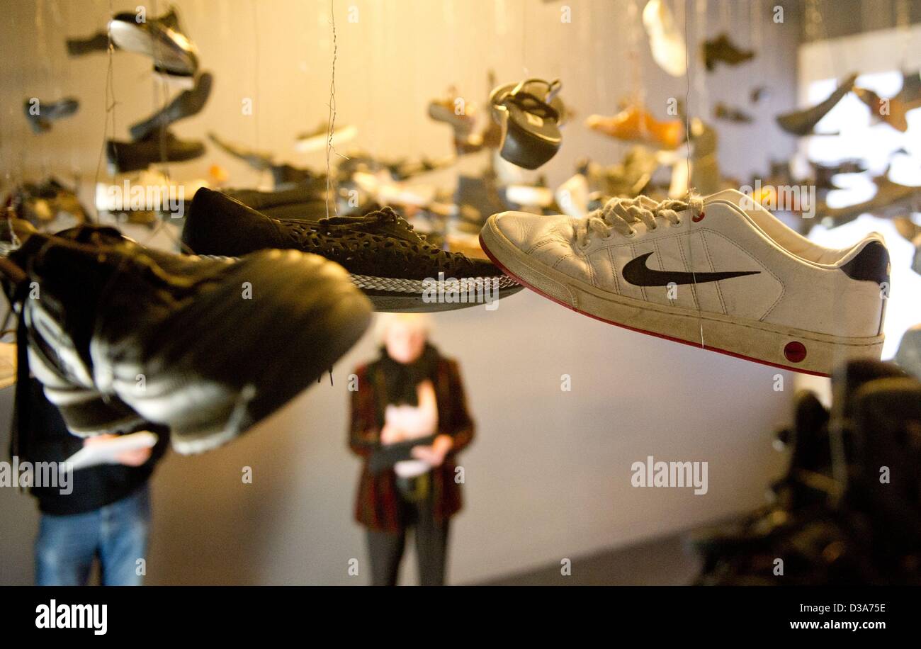 Goslar, Germany. 14th February 2013. A journalist stands next to the  installation 'Flying shoes' by Christian Boltanski at the exhibition  'Highlights of Modern Art - Works of Goslarer Kaiserring awardees  (1975-2013)' in