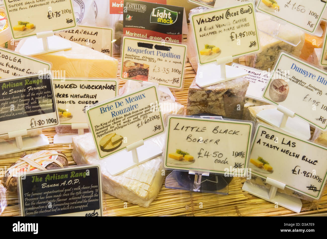 Selection of cheeses at a delicatessen counter. Stock Photo