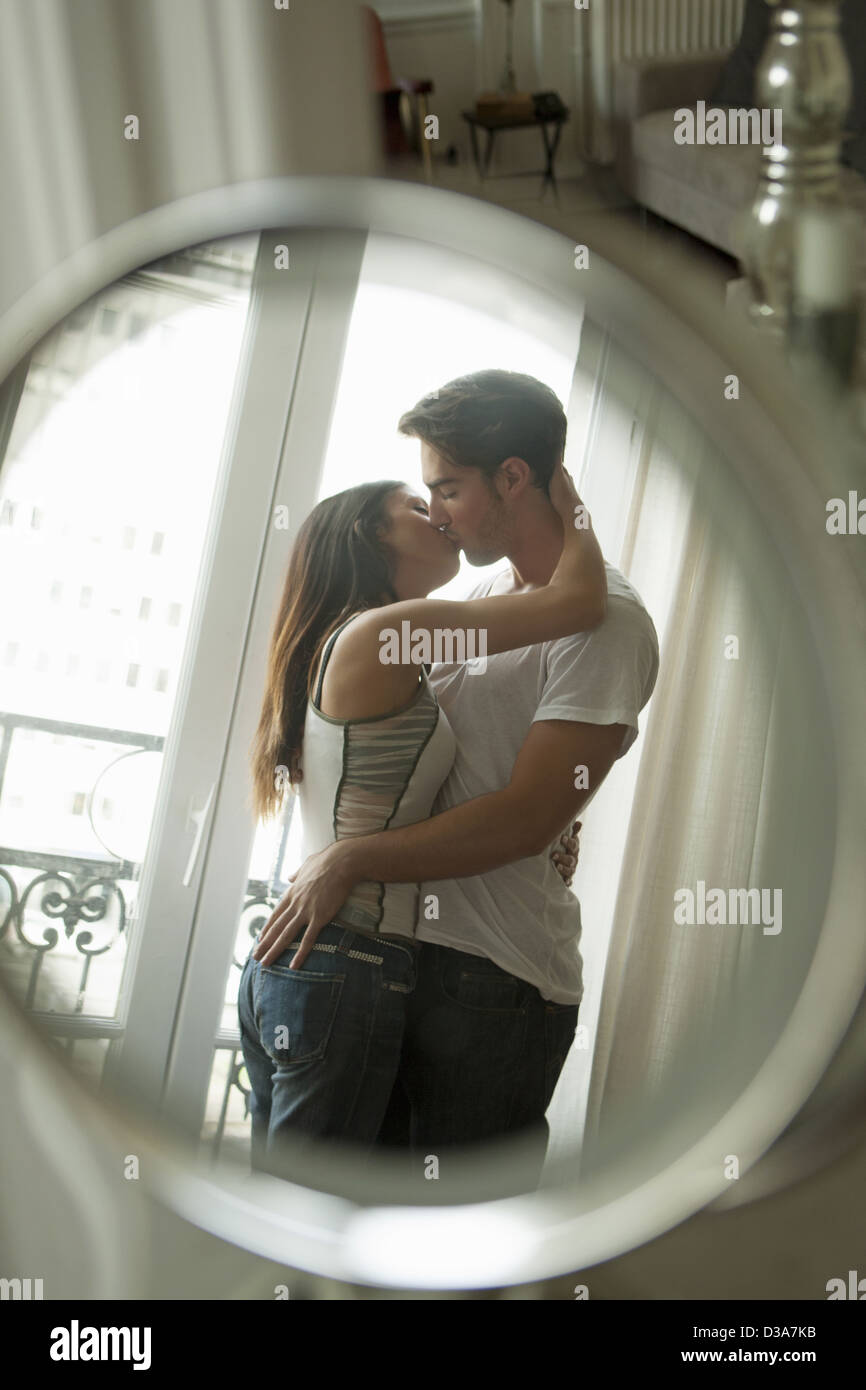 Couple kissing in mirror Stock Photo