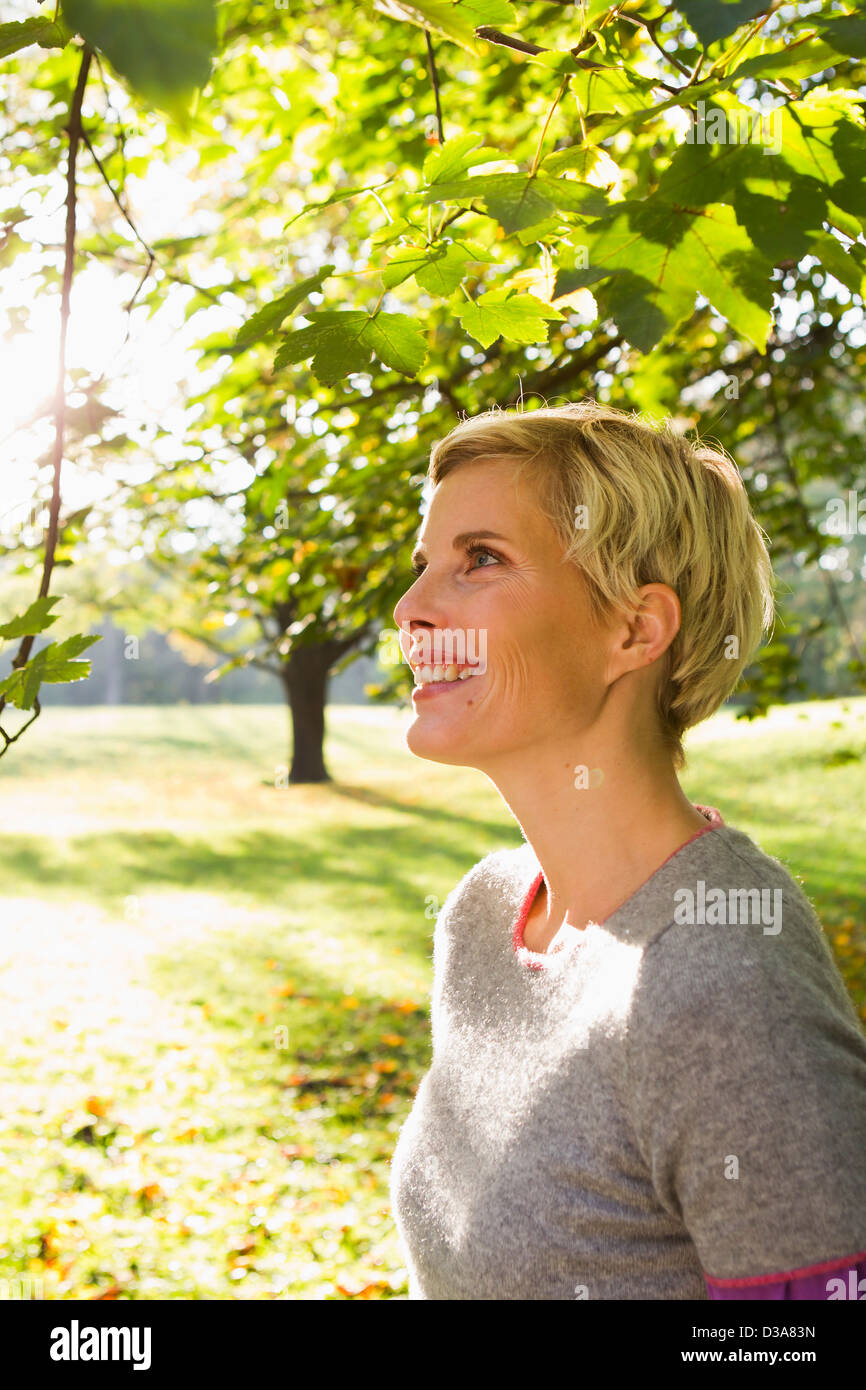 Woman smiling in park Stock Photo - Alamy
