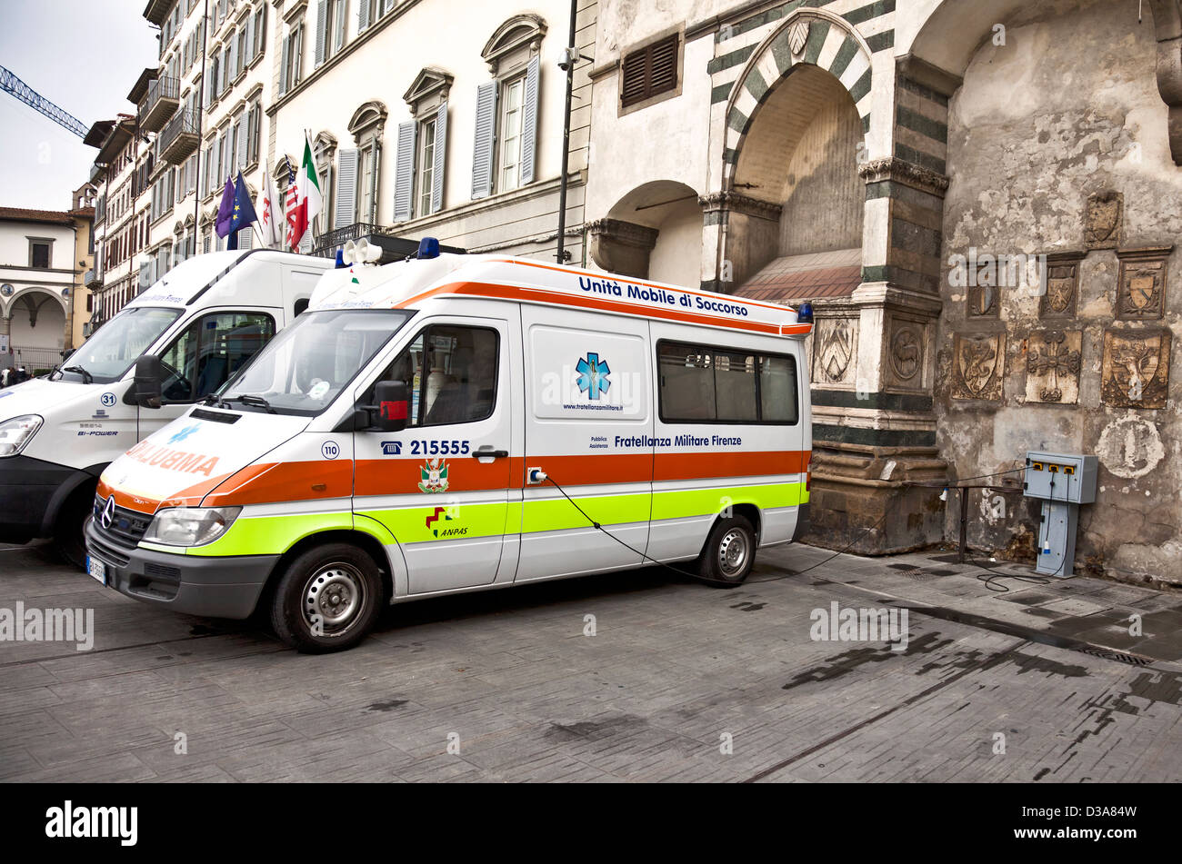 An ambulance of the Fratellanza Militare (Military brotherhood) being recharged at an electric point in Florence, Italy. Stock Photo