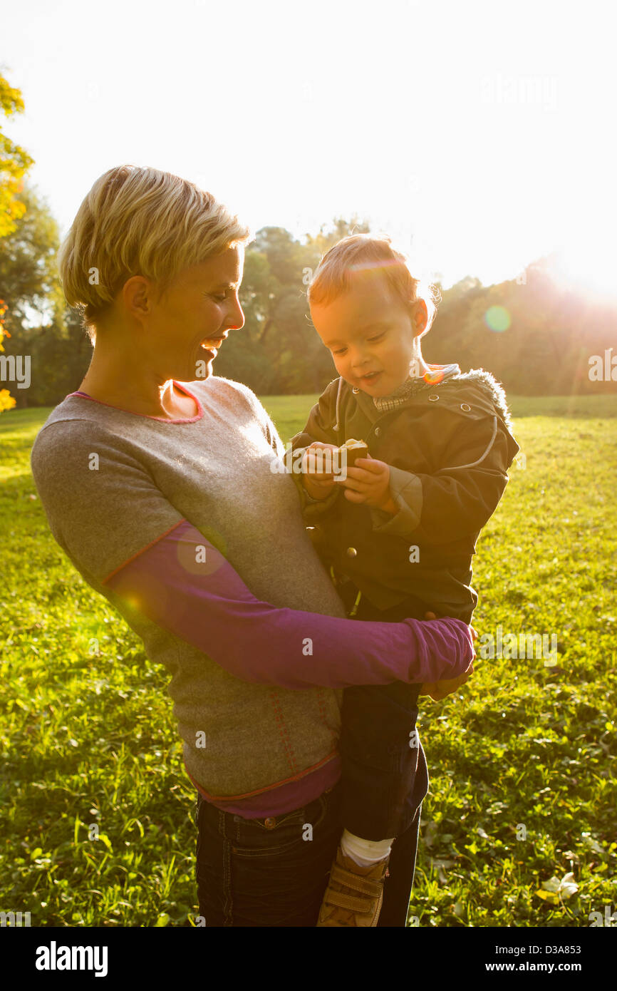 Mother holding son in park Stock Photo