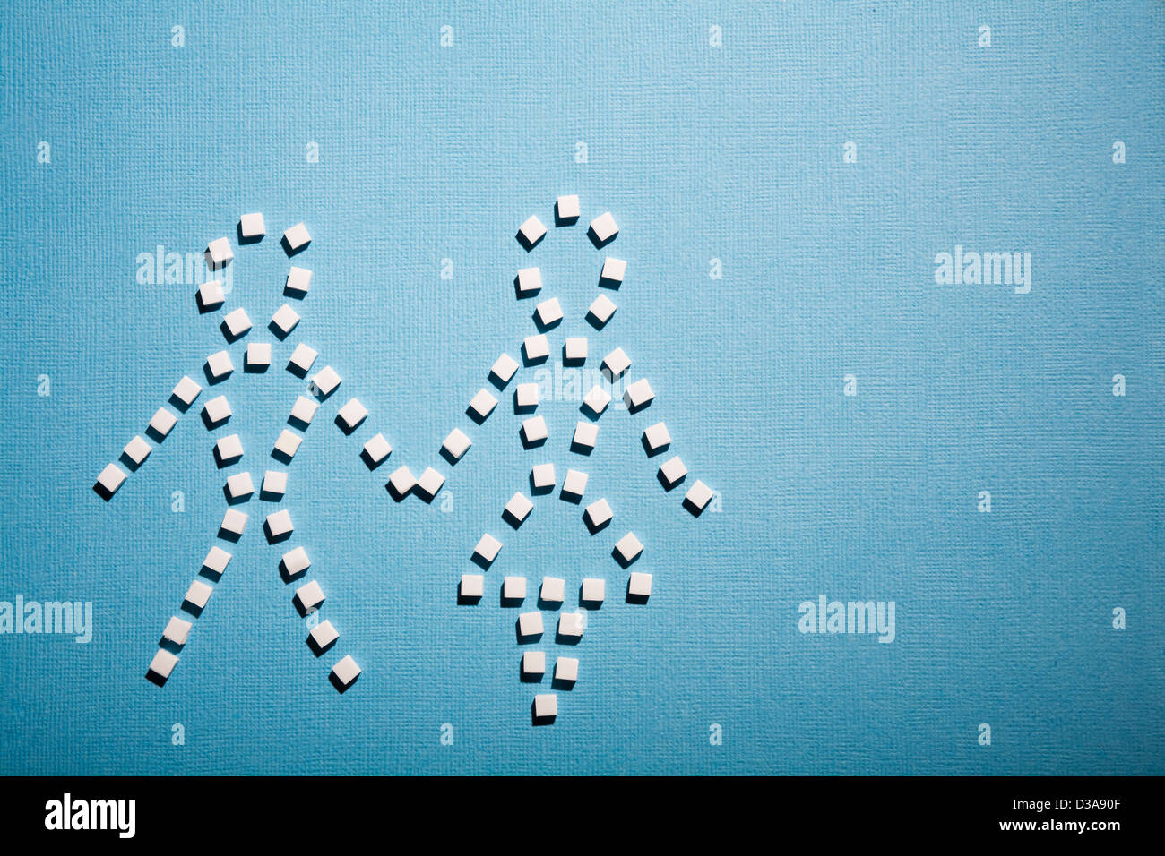 Sugar cubes in shape of couple Stock Photo