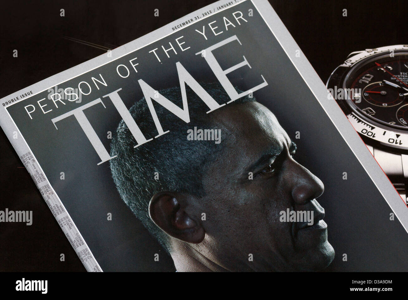 Time magazine cover photo (December 2012/Jan 2013) of Barack Obama, juxtaposed with interior watch advertisement. Stock Photo