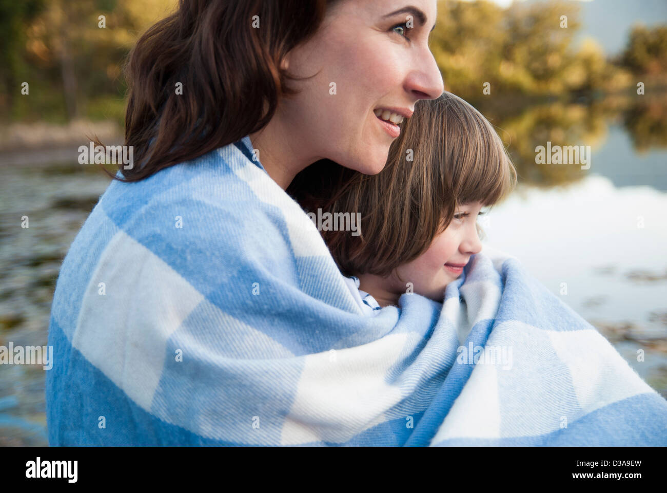 Mother and daughter wrapped in blanket Stock Photo Alamy