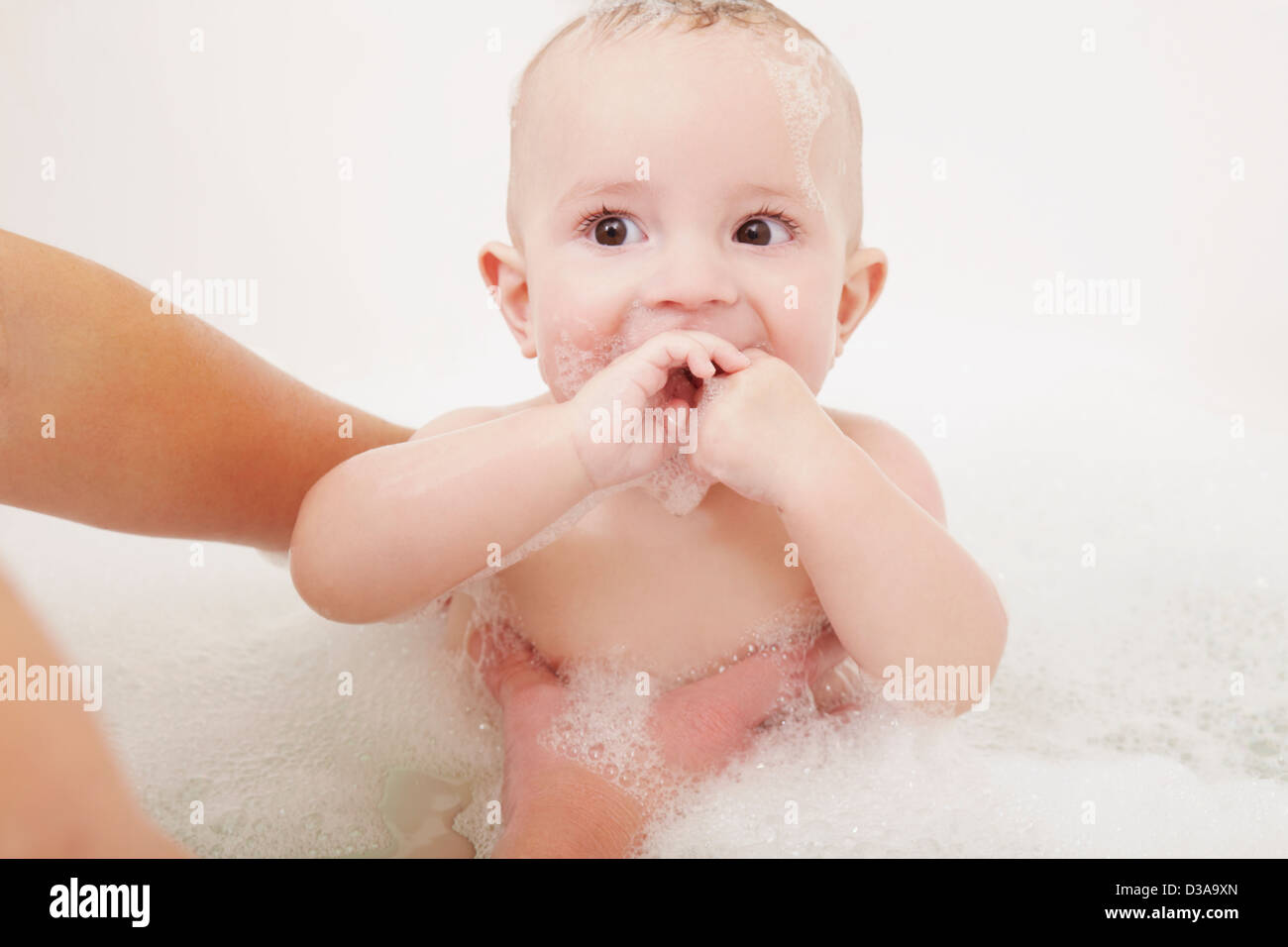 Mother washing baby girl in bubble bath Stock Photo Alamy