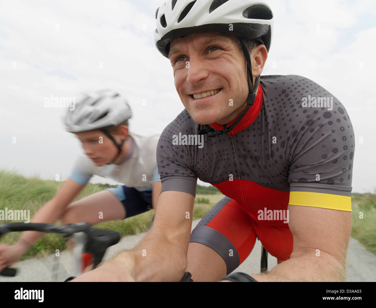 Father and son cycling on rural road Stock Photo