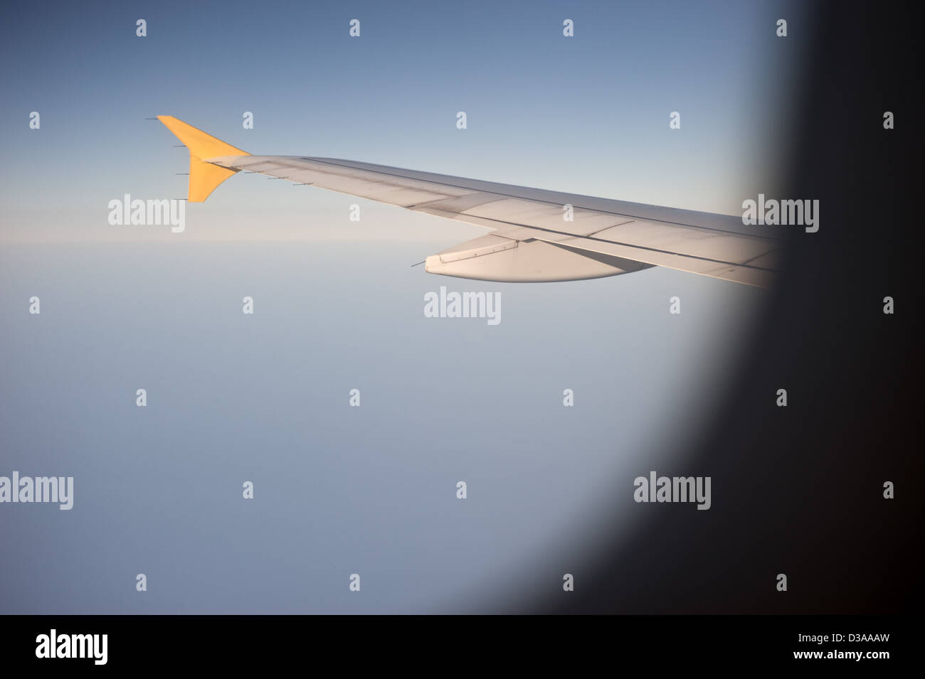 Wing through the window of the plane Stock Photo - Alamy