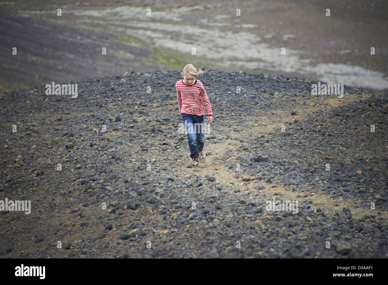 Girl walking in rocky landscape Stock Photo