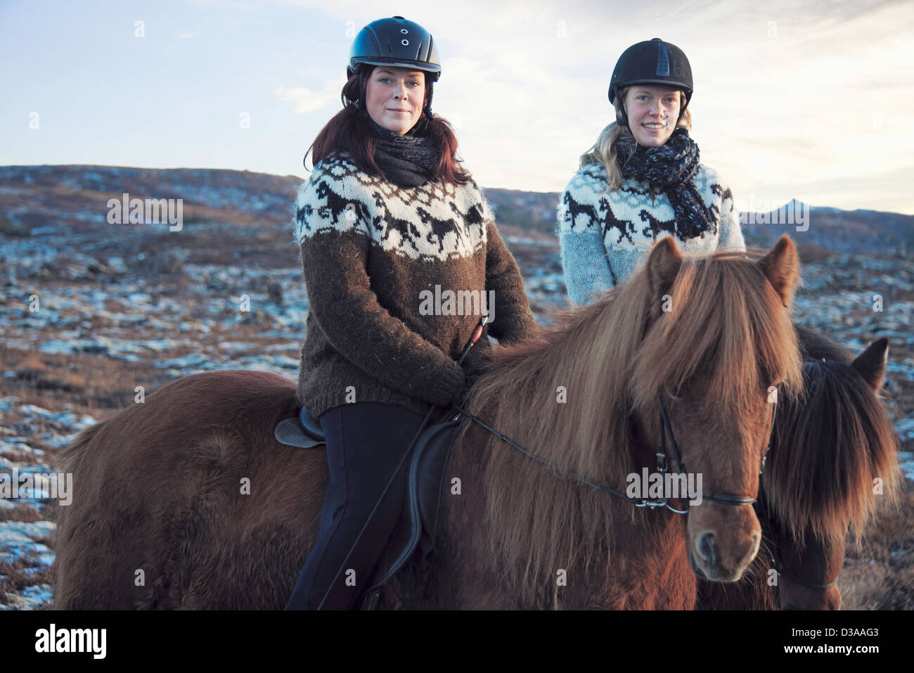 Women riding horses outdoors Stock Photo