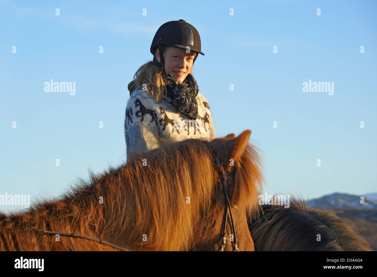 Woman riding horse outdoors Stock Photo