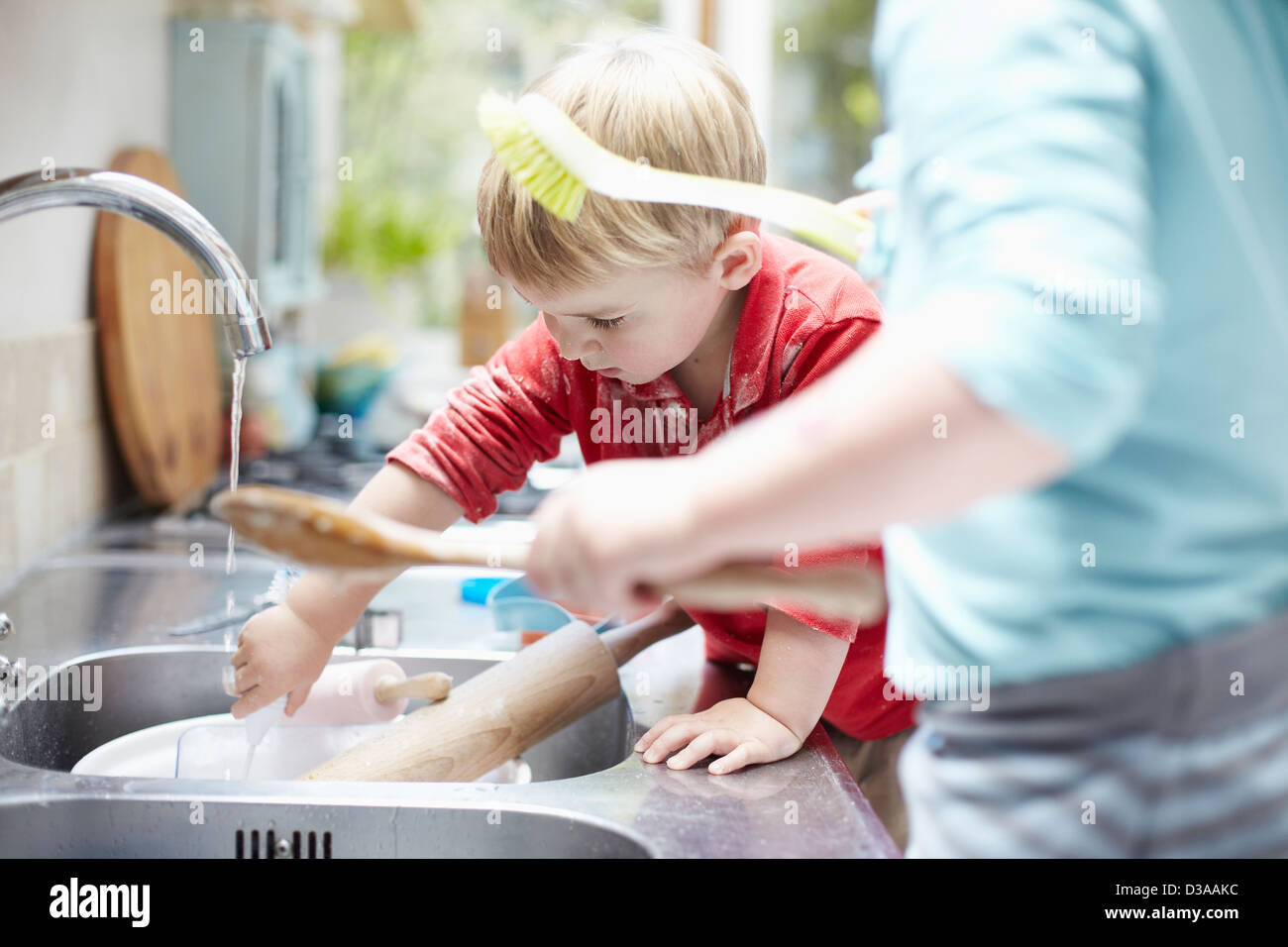 Children washing dishes together Stock Photo Alamy