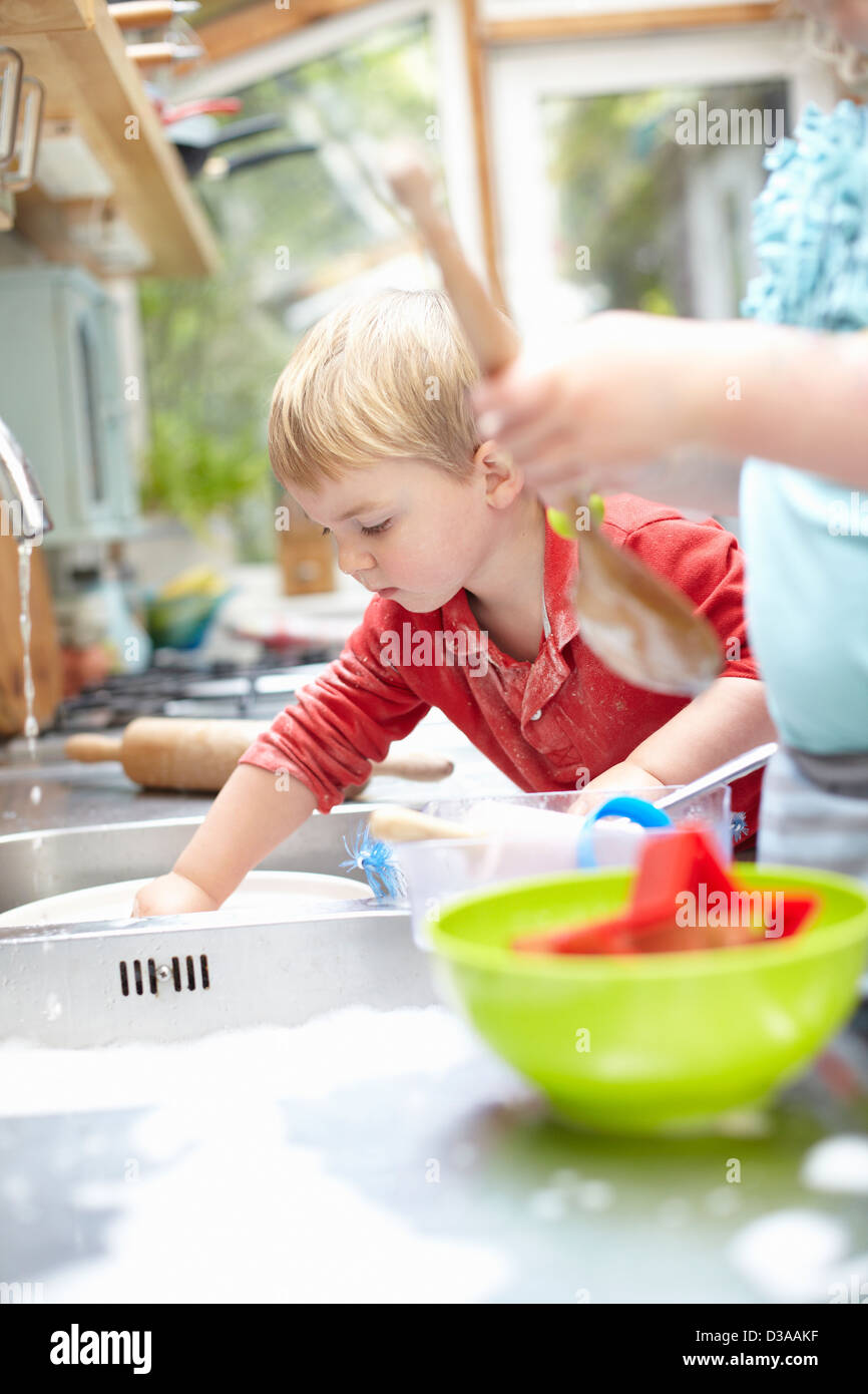 Children washing dishes together Stock Photo Alamy