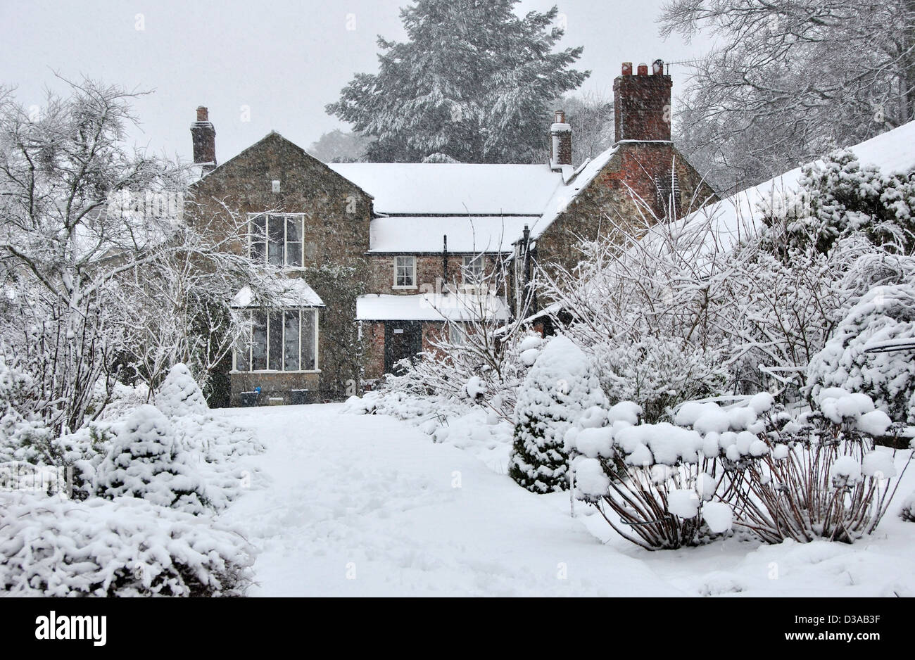 A snow covered house and garden UK Stock Photo