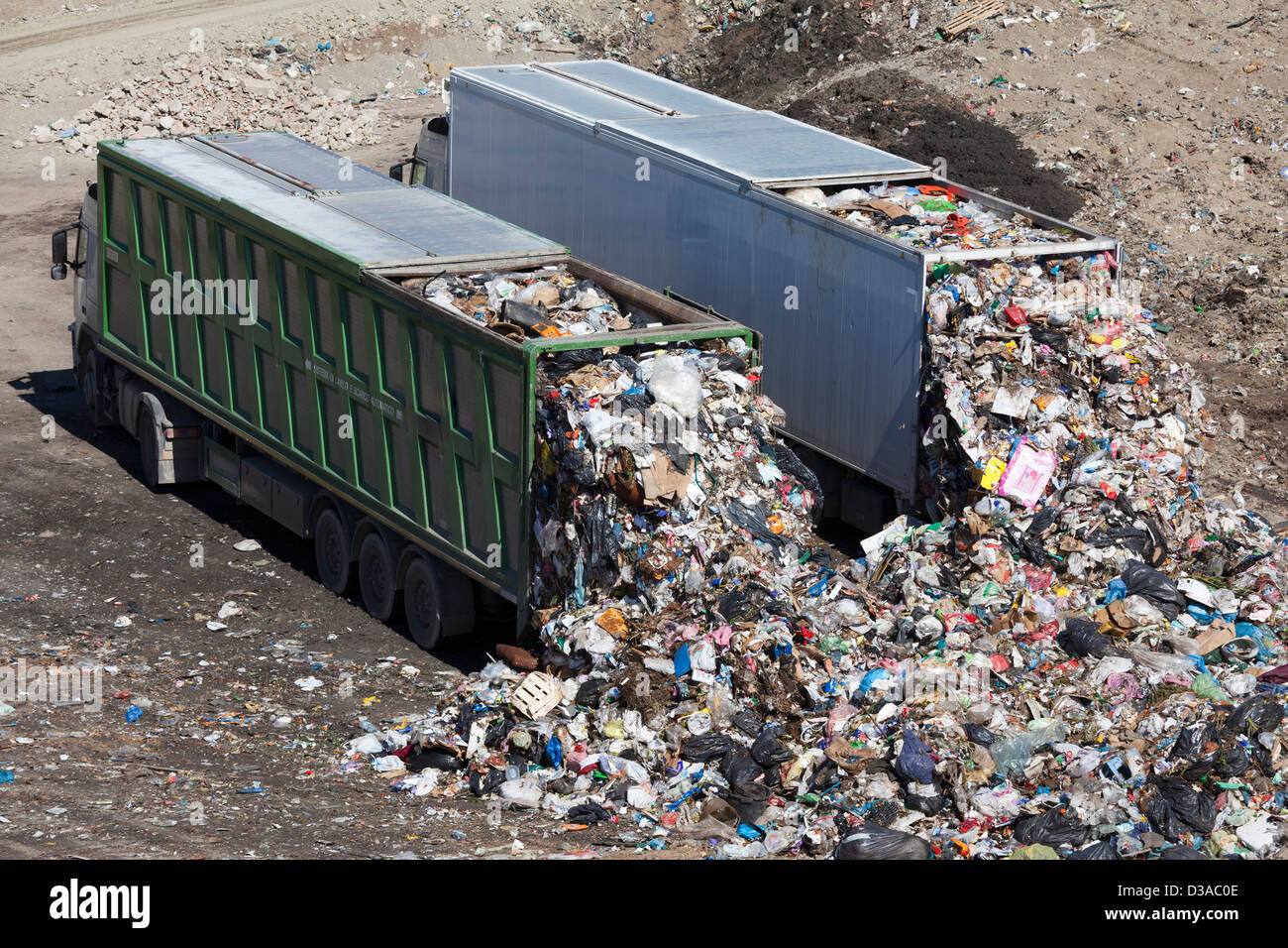Trucks dumping waste in landfill Stock Photo Alamy