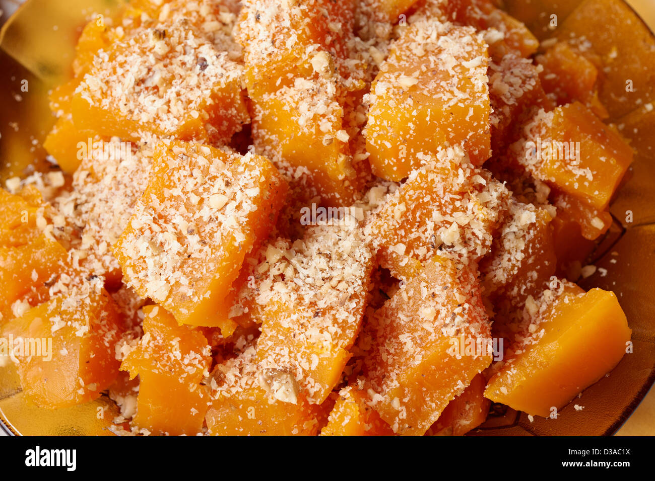 Traditional Bulgarian Christmas vegetarian food - boiled pumpkin with walnuts on holiday table Stock Photo