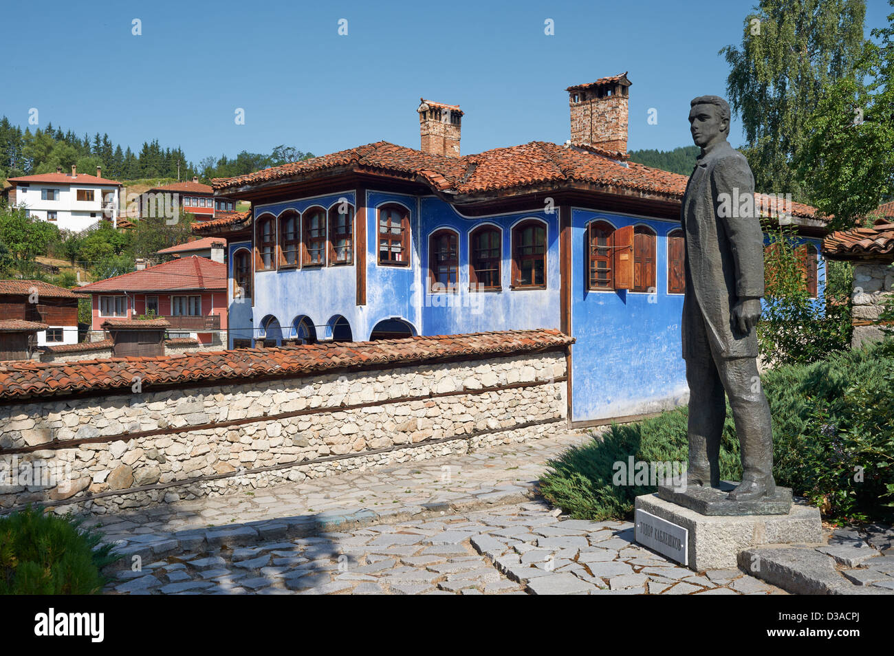 Street and house in Koprivshtitsa, Bulgaria with the monument of Todor Kableshkov Stock Photo