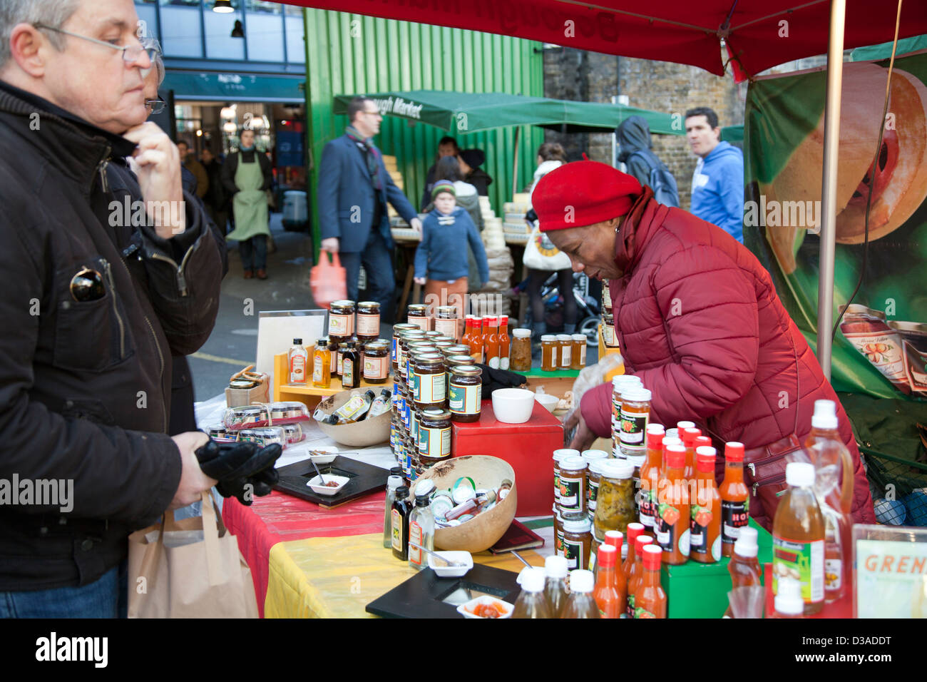 Man Buying Jars of Sauce from Grenada Stall at Borough Market in London