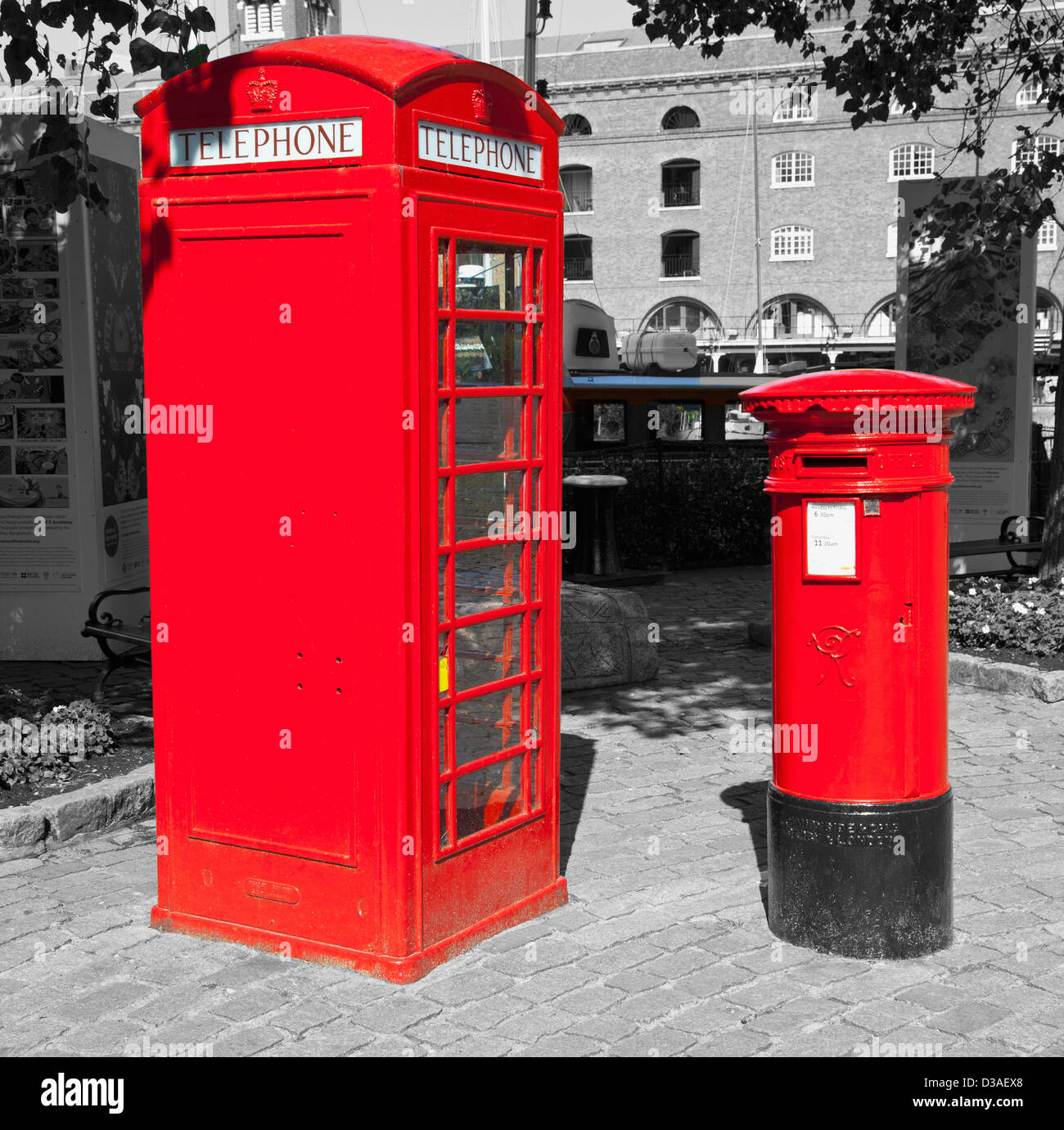 A traditional red English public phone and post box with background in black and white Stock Photo