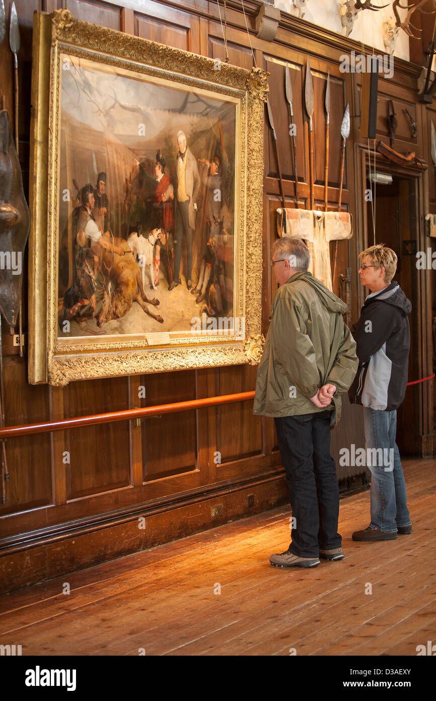 Two men look at a painting in the Entrance hall of Blair castle in the village of Blair Atholl, Perthshire, Scotland Stock Photo