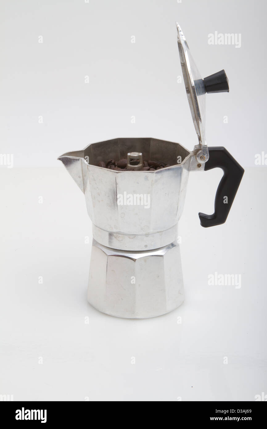 Heating up espresso coffee in a Cuban coffee maker using a mini gas stove  with a Coleman propane tank on a single burner. A thunderstorm is  approaching Stock Photo - Alamy