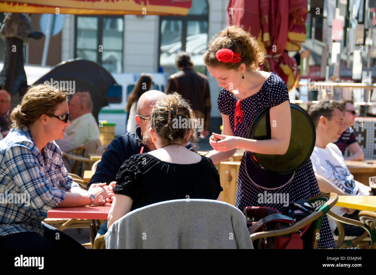 A black-dressed waitress taking an order from a customer at a restaurant  in Riga old town,Riga, Latvia, Baltic States Stock Photo