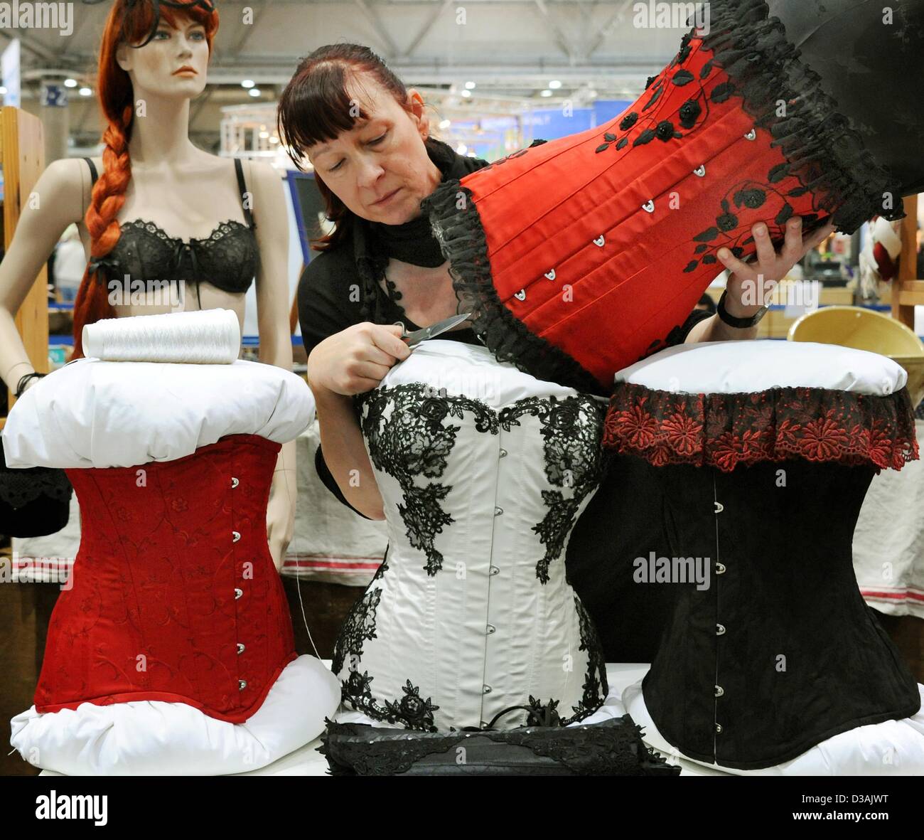Corset maker Heike Taubert from Frohburg works on a silk corset at the  Mitteldeutsche Handwerksmesse (Central Germany Handicraft Fair) in Leipzig,  Germany, 13 February 2013. 245 exhibitors are shows their handicraft  products