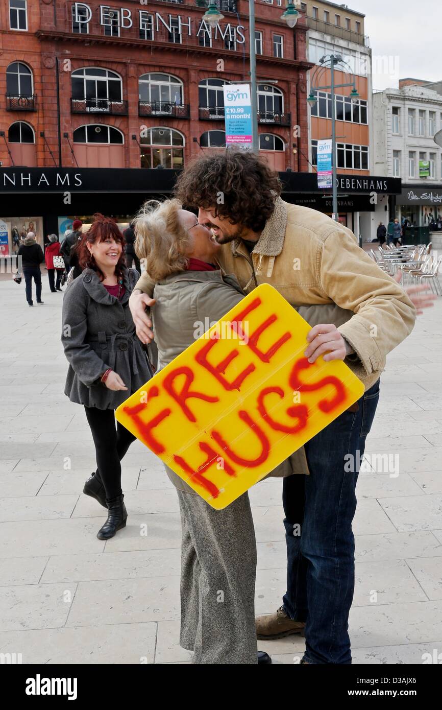 Bournemouth, UK. 14th February 2013. The free Hugs campaign involves individuals who offer hugs to strangers. The intention is to make others feel better as a result of a random act of kindness. Chris, the young man in the picture, said 'hugs should be for every day and not just Valentines Day'. Credit: Tom Corban/Alamy live News Stock Photo