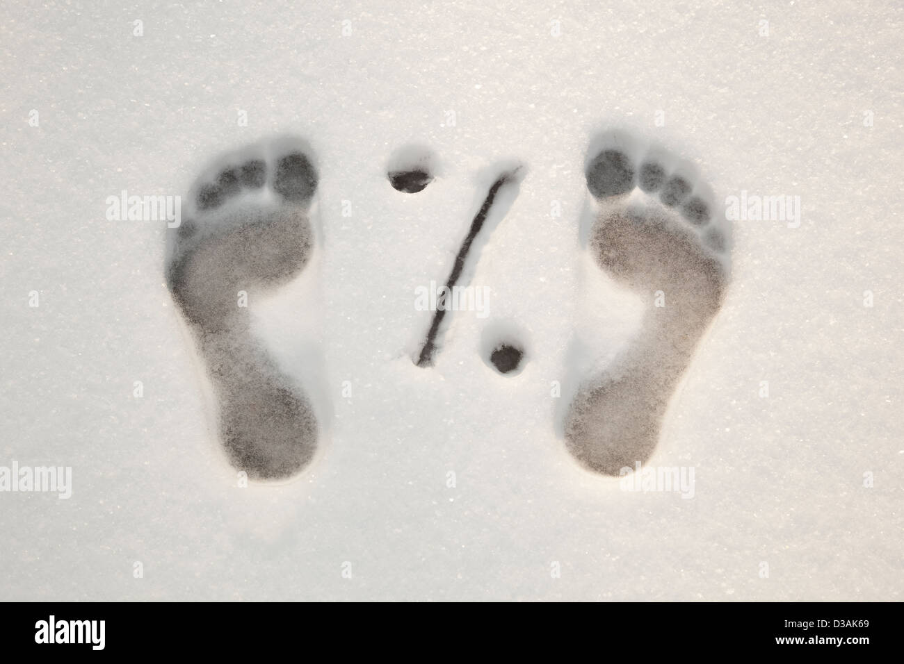 traces of barefooted foot on white snow Stock Photo