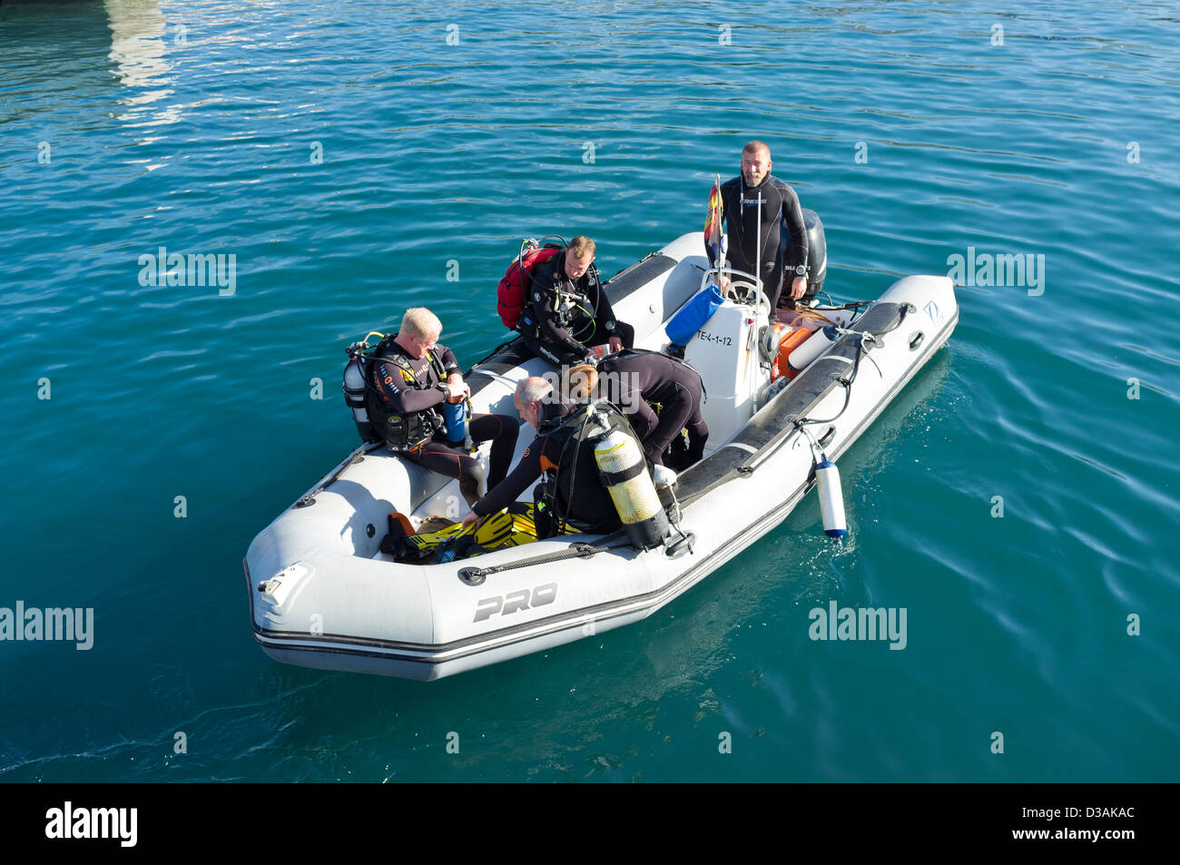 Divers getting ready to go on a dive leaving the harbour in a rib, semi rigid inflatable boat, Playa San Juan, Tenerife, Stock Photo