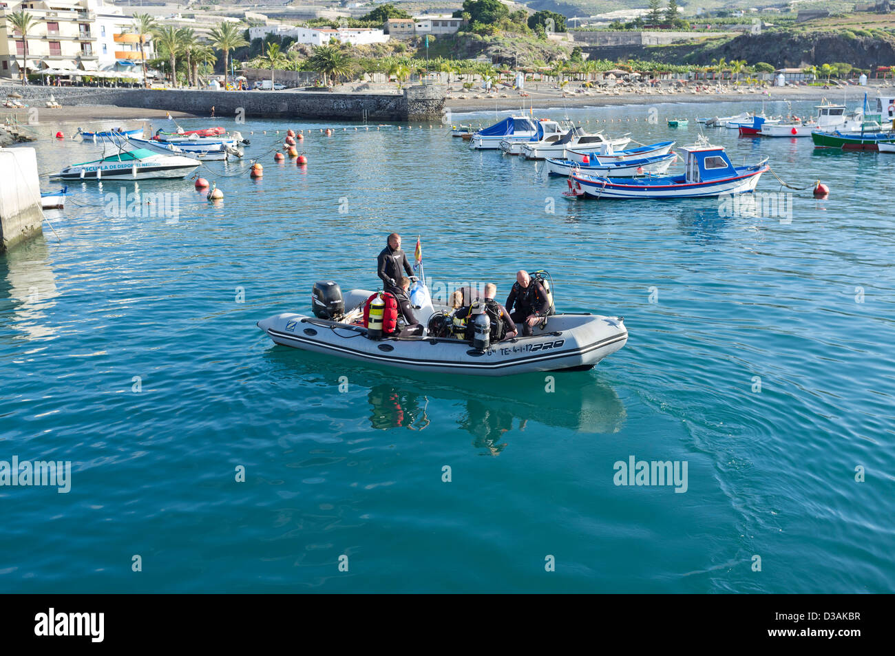 Divers getting ready to go on a dive leaving the harbour in a rib, semi rigid inflatable boat, Playa San Juan, Tenerife, Stock Photo