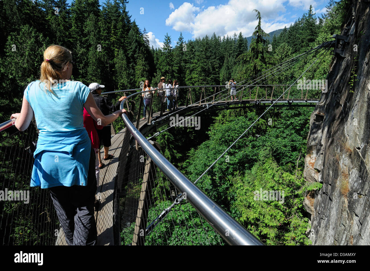 Tourists on the Cliffwalk at Capilano Suspension Bridge Park Vancouver cantilevered suspended walkway thrill high height Stock Photo