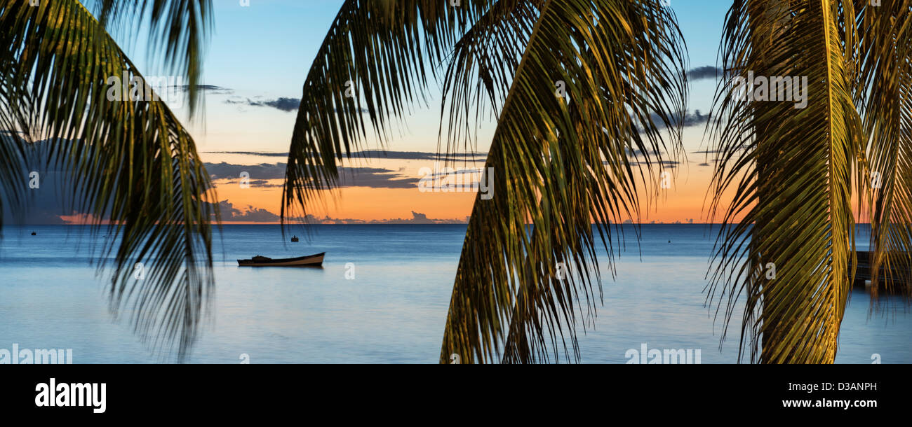 Lonely Boat At Sunset, city of Saint Pierre, Martinique, France Stock Photo