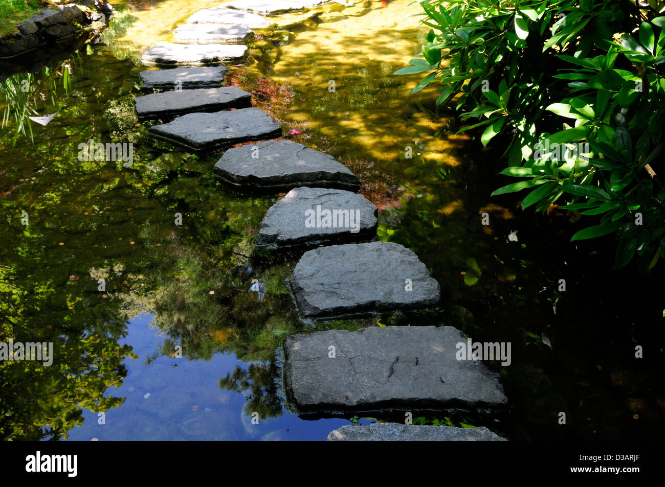 Japanese Garden section area The Butchart Gardens Brentwood Bay Victoria British Columbia Canada stepping stones curved path Stock Photo