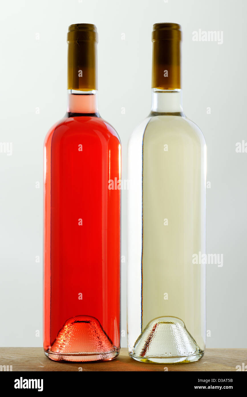 Two bottles of red and white wine, sealed, without labels Stock Photo
