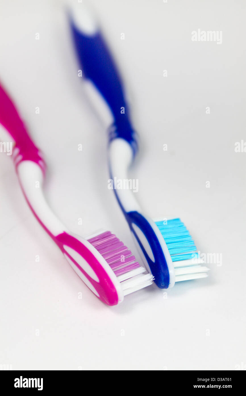 Pink and blue his and hers toothbrushes Stock Photo